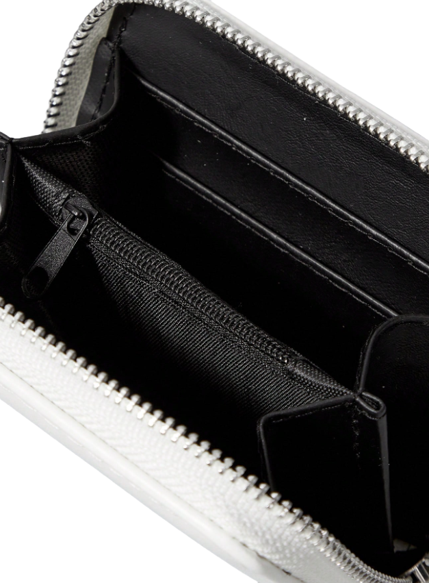 Close-up of a white wallet with a zipper, showing the interior.